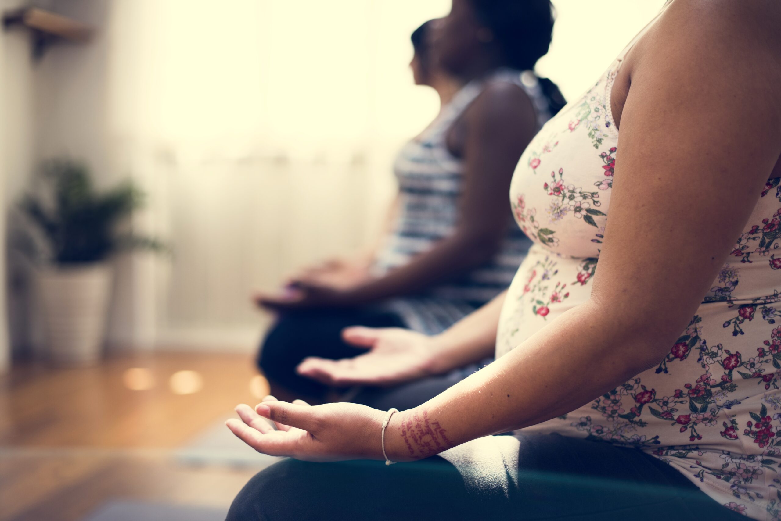 Pregnant woman in yoga class